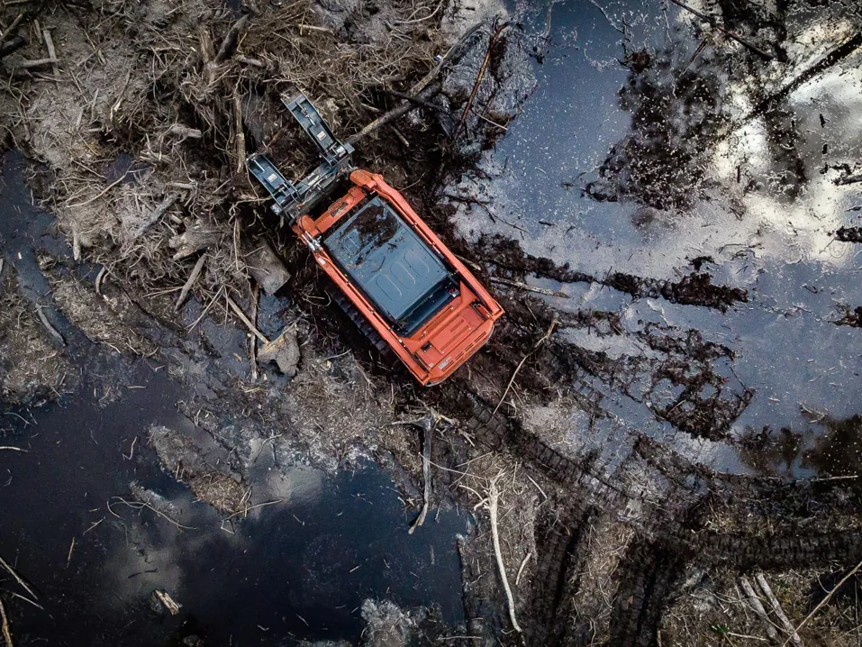 Overhead view of a track loader on a cleared wet site, site preparation